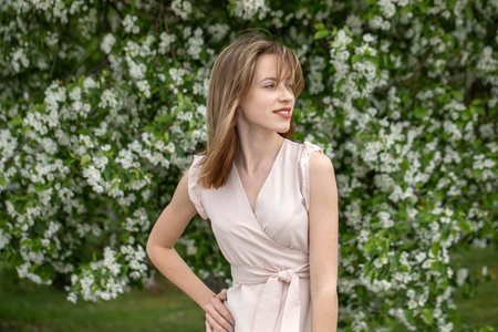 Young beautiful girl posing in a blooming gardenの写真素材