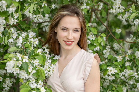 Young beautiful girl posing in a blooming gardenの写真素材