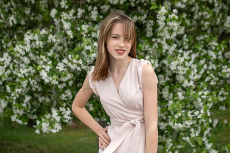 Young beautiful girl posing in a blooming gardenの写真素材
