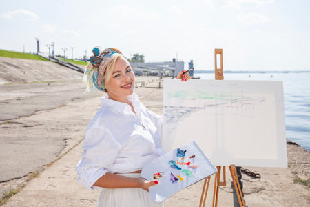 Female artist paints a cityscape in Samaraの写真素材