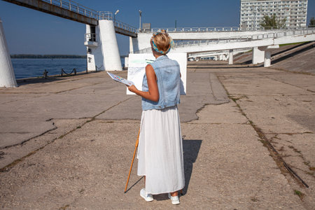 Female artist paints a cityscape in Samaraの写真素材
