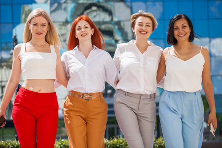 Happy portrait of four business women outdoorsの写真素材