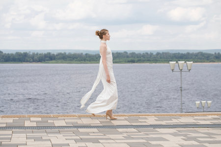 Young beautiful woman in a long white dressの写真素材
