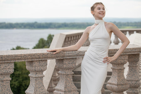Young beautiful woman in a long white dressの写真素材