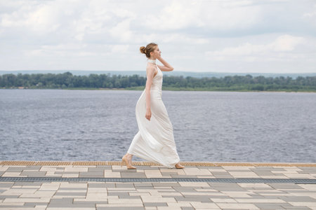 Young beautiful woman in a long white dressの写真素材