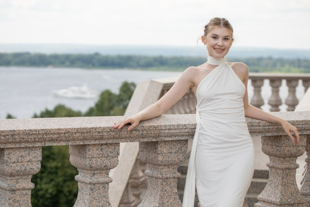 Young beautiful woman in a long white dressの写真素材