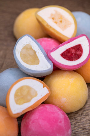 Mochi - sweet Japanese dessert. Whole and pieces of dessert on a wooden boardの写真素材