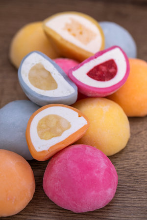 Mochi - sweet Japanese dessert. Whole and pieces of dessert on a wooden boardの写真素材