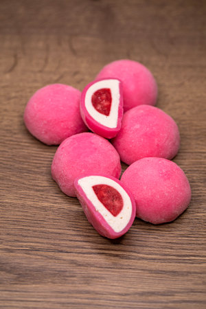 Mochi - sweet Japanese dessert. Whole and pieces of dessert on a wooden boardの写真素材