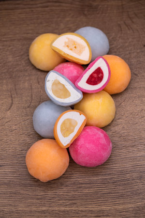 Mochi - sweet Japanese dessert. Whole and pieces of dessert on a wooden boardの写真素材