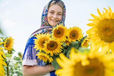 Slavyanka. Portrait of a young beautiful girl in a field of sunflowers