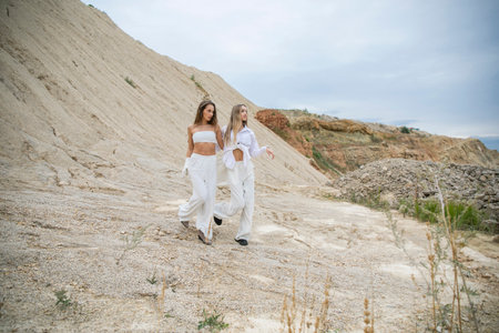 Full length portrait of two young girlfriends posing in Padovskiy quarryの写真素材