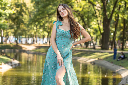 Fashion portrait of a young woman in a turquoise dress