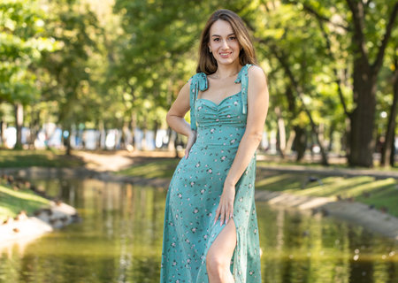 Fashion portrait of a young beautiful woman in a turquoise dress