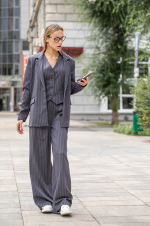 Business woman. Full body portrait of a blonde model, street outdoorの写真素材