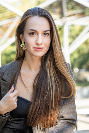 Close up portrait of a young attractive brown-haired woman in summer parkの写真素材