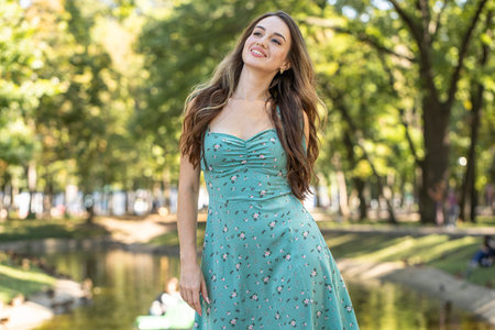Fashion portrait of a young beautiful woman in a turquoise dressの写真素材