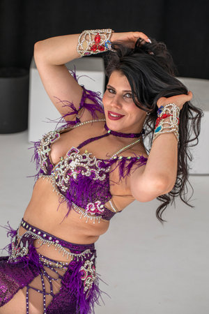Portrait of a young attractive brunette woman in oriental dance costume