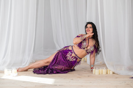 Portrait of a young attractive brunette woman in oriental dance costumeの写真素材