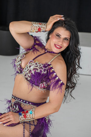 Portrait of a young attractive brunette woman in oriental dance costume