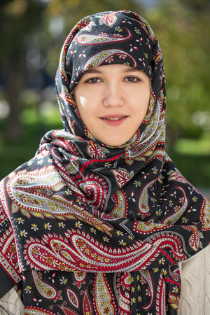 Portrait of a young girl with a scarf on her head