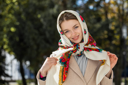 Portrait of a young beautiful girl with a scarf on her headの写真素材