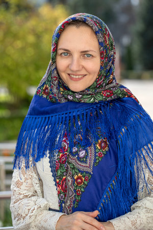 Portrait of a young beautiful girl with a scarf on her headの写真素材