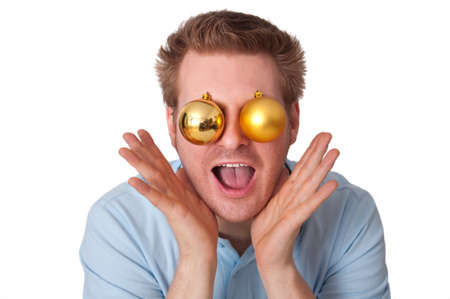 Funny Image: Happy excited and surprised young man with Christmas balls as eyes shouting and screaming with handsの写真素材