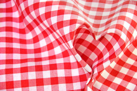 Red and white checkered textile folded like a heartの写真素材