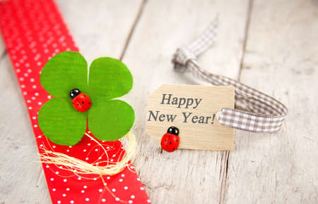 Good luck greeting card with label and message for new years eve on wooden backgroundの写真素材