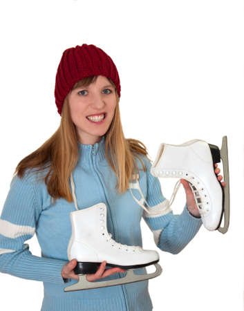 ice skating happy girl showing ice skates in front of white backdropの写真素材