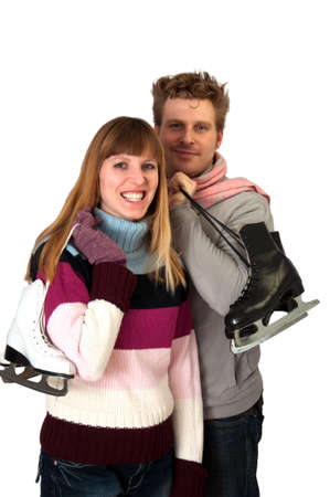 happy ice skating young woman and man on white backdrop の写真素材