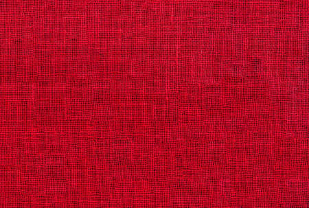 red raw organic fabric sackcloth canvas woven textile backdropの写真素材