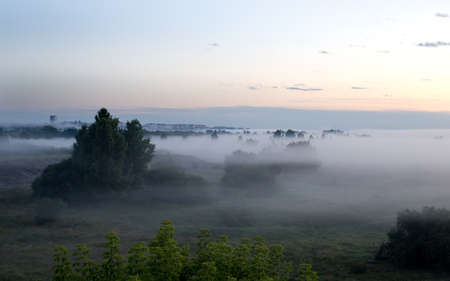Thick fog in the early morning in the calm river valleyの写真素材