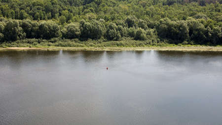 Lake shore, water surface of calm wateの写真素材