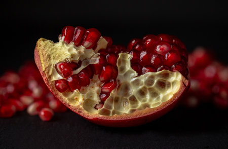 Red fruits of ripe pomegranate, juicy grains of healthy fruitの写真素材