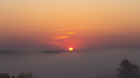 Misty dawn in the early morning. Morning fog in nature. Fog in early morning. Sunrise with fogの写真素材