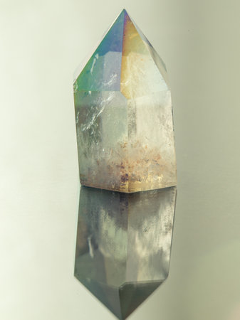 Closeup picture of pure quartz mineral gemstone isolated on a gray backgroundの写真素材