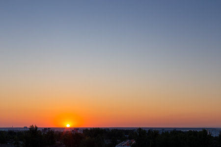 The setting sun on the horizon, spacious fields and meadows of Europeの写真素材