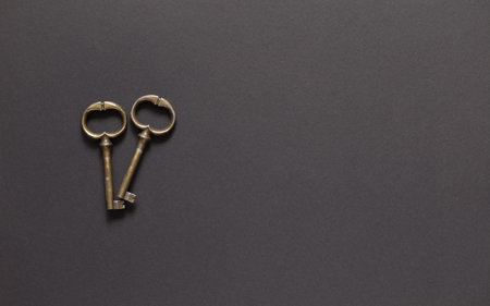 Antique metal keys on a dark insulated backgroundの写真素材