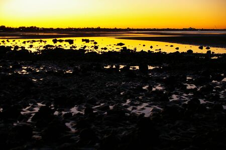 Sunset silhouette beach dusk scene の写真素材