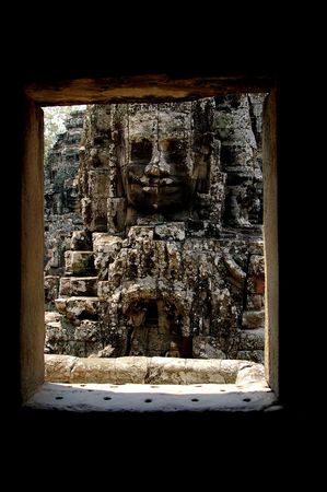 face of a ruler framed by a doorway bayon temple angorの写真素材