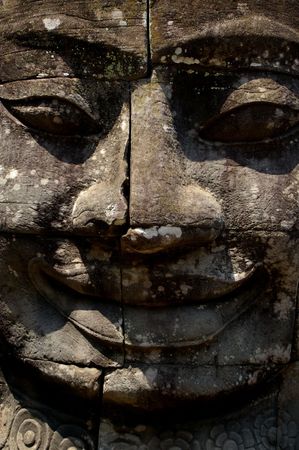 smiling giant head of bayon temple angkor cambodiaの写真素材