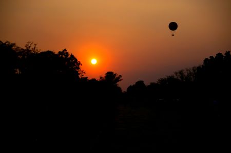 silhouetted hot air balloon over Angkor wat cambodiaの写真素材