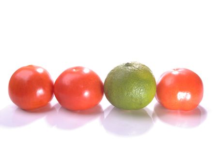 stand out lime in the line up of tomatoesの写真素材