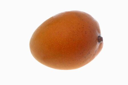 Single orange mango isolated on white background