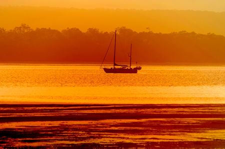 yacht moored for sunrise views of tin can bayの写真素材
