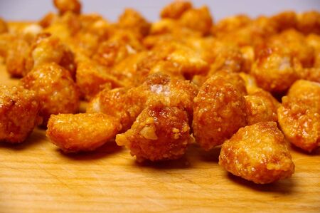 honey roasted macadamia nut on wooden boardの写真素材