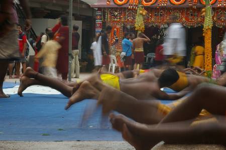 Hindus doing ritual rolling at sri Mariamman  temple for the Thimithi festival Angapirathatchanam...