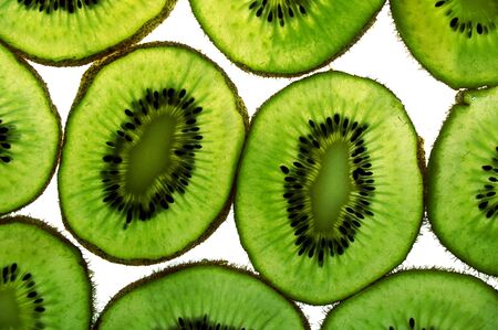 close up of kiwi fruit slices on white backgroundの写真素材